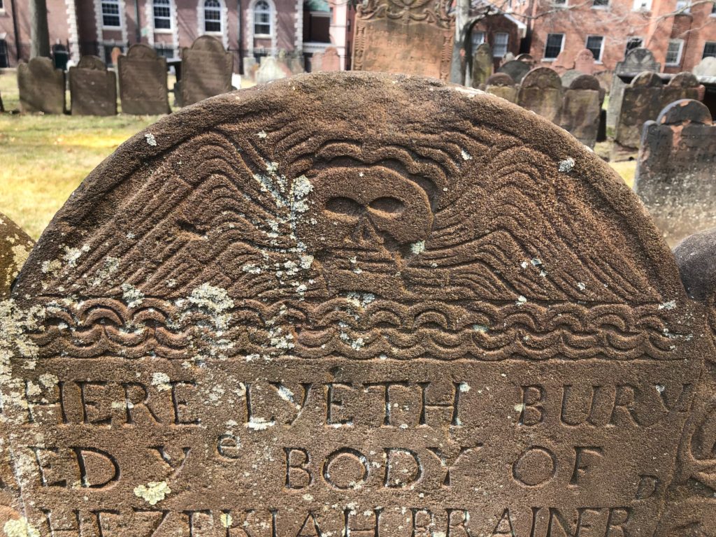 Gravestone featuring winged death's head in Central Church's Ancient Burial Ground, Hartford, CT